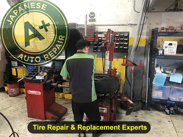 Tire Repair & Replacement Experts - Image shows a technician working on a tire - A+ Japanese Auto Repair Inc. - San Carlos, CA